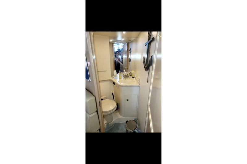 Slide: The Image of Bathroom interior of 2000 Carver 406 Aft Cabin Motor Yacht, featuring compact design and nautical decor. - 41
