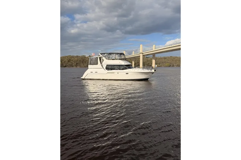 Slide: The Image of 2000 Carver 406 Aft Cabin Motor Yacht on calm water near a bridge. - 45