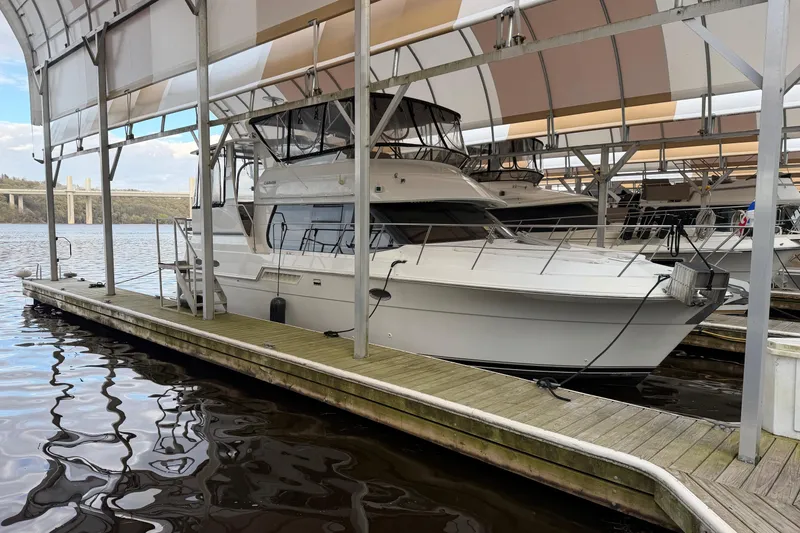 Slide: The Image of 2000 Carver 406 Aft Cabin Motor Yacht docked under covered marina. - 48