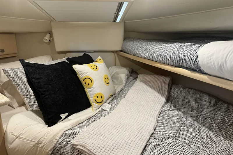 Slide: The Image of Cozy cabin interior of 2000 Carver 406 Aft Cabin Motor Yacht with plush bedding. - 5
