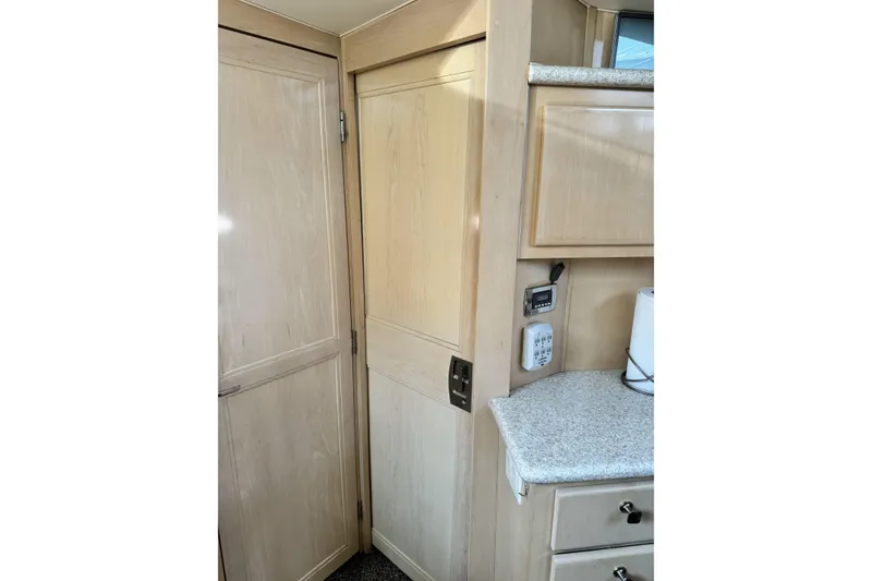 Slide: The Image of Interior of 2000 Carver 406 Aft Cabin Motor Yacht with wooden cabinetry and countertop. - 7
