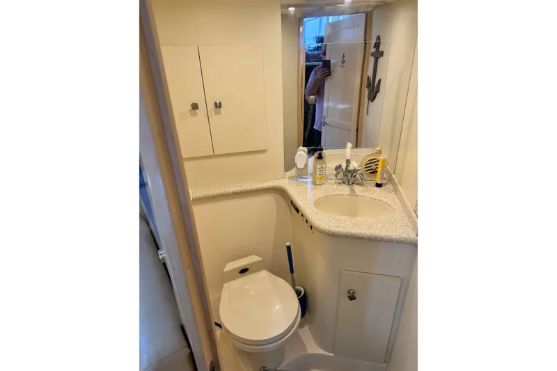 Slide: The Image of Bathroom interior of 2000 Carver 406 Aft Cabin Motor Yacht, featuring sink and toilet. - 8