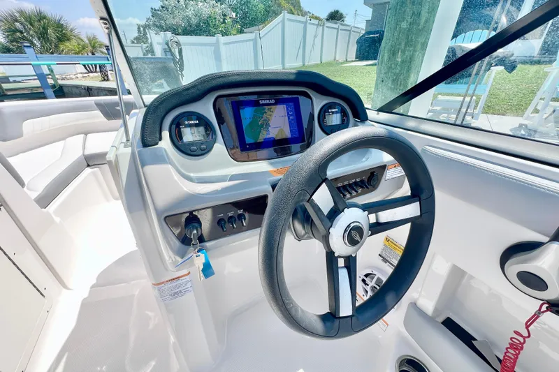 Slide: The Image of 2023 Chaparral 21 SSi OB boat dashboard with steering wheel and navigation display. - 18