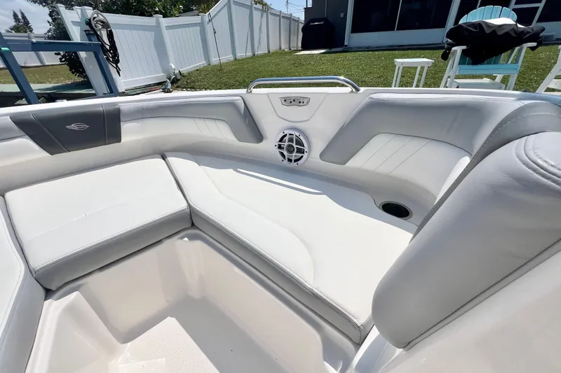 Slide: The Image of 2023 Chaparral 21 SSi OB boat interior with white seating and speaker. - 23