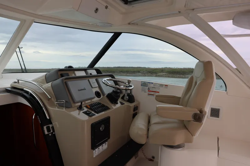 Slide: The Image of 2015 Pursuit OS 385 Offshore boat with spacious deck and triple outboard engines. - 14