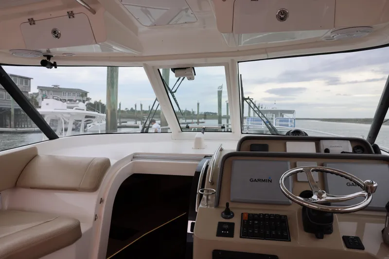 Slide: The Image of Helm of 2015 Pursuit OS 385 Offshore boat with Garmin navigation system. - 16
