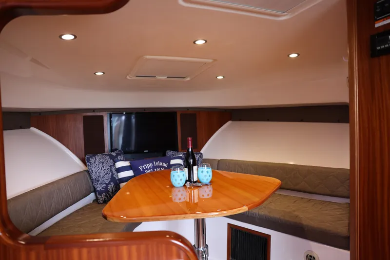 Slide: The Image of Interior view of 2015 Pursuit OS 385 Offshore boat with beige seating. - 19