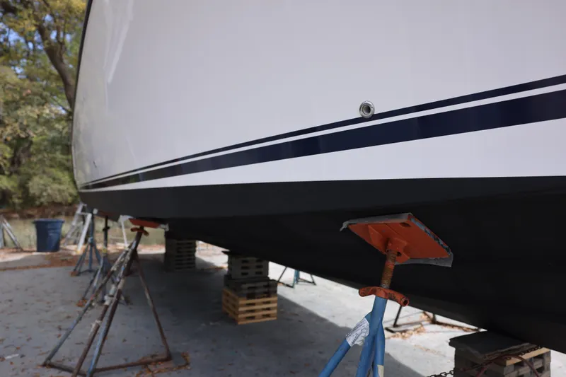 Slide: The Image of 2015 Pursuit OS 385 Offshore boat on stands for maintenance. - 2