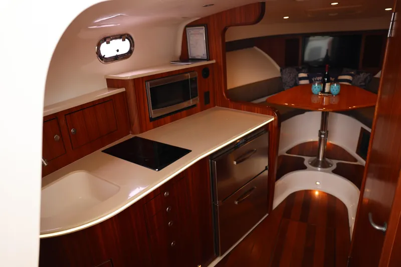 Slide: The Image of Luxurious interior of 2015 Pursuit OS 385 Offshore yacht with cozy seating and elegant table. - 22