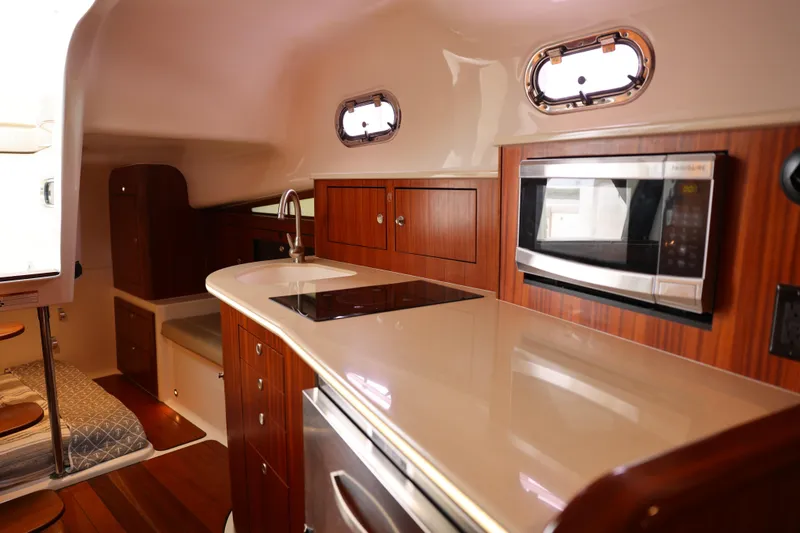 Slide: The Image of Luxurious interior of 2015 Pursuit OS 385 Offshore yacht with cozy seating and table. - 23