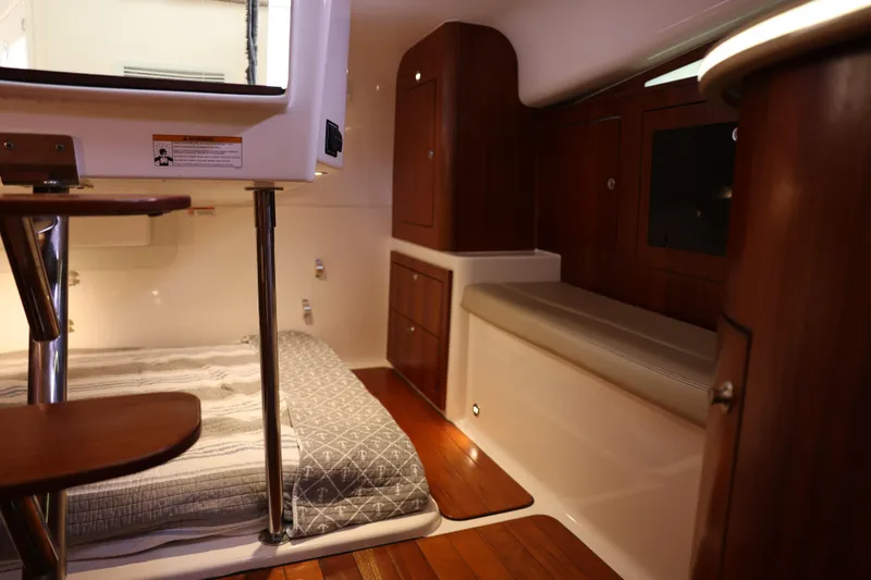 Slide: The Image of Luxurious 2015 Pursuit OS 385 Offshore yacht kitchen with modern appliances and wood finish. - 24