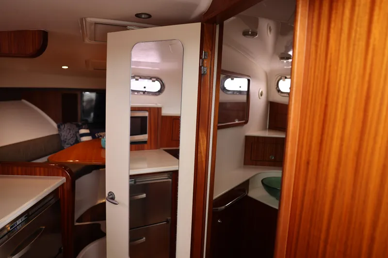 Slide: The Image of Luxurious 2015 Pursuit OS 385 Offshore yacht kitchen with wood cabinetry and modern appliances. - 25