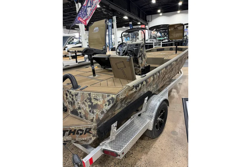Slide: The Image of 2026 Thor Lake Hammer 1900 boat with camouflage design on display in showroom. - 3