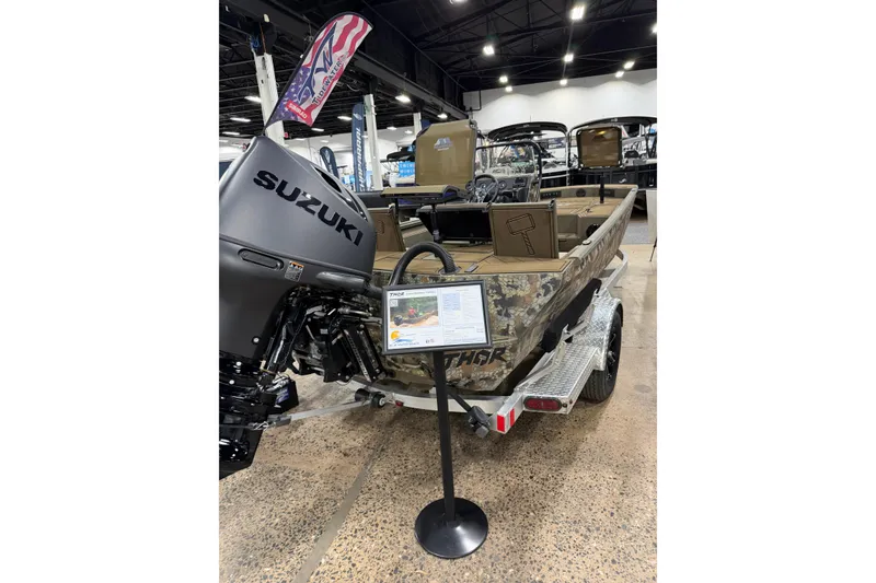 Slide: The Image of 2026 Thor Lake Hammer 1900 boat with Suzuki engine on display at a showroom. - 5
