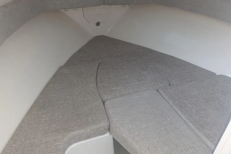 Slide: The Image of 2023 Grady-White Adventure 218 cabin interior with cushioned seating. - 10