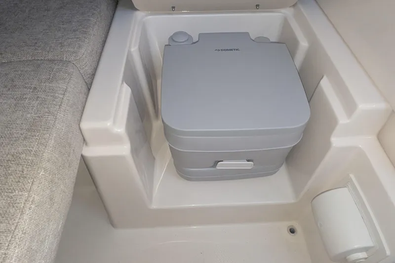 Slide: The Image of Portable toilet in 2023 Grady-White Adventure 218 boat interior. - 11