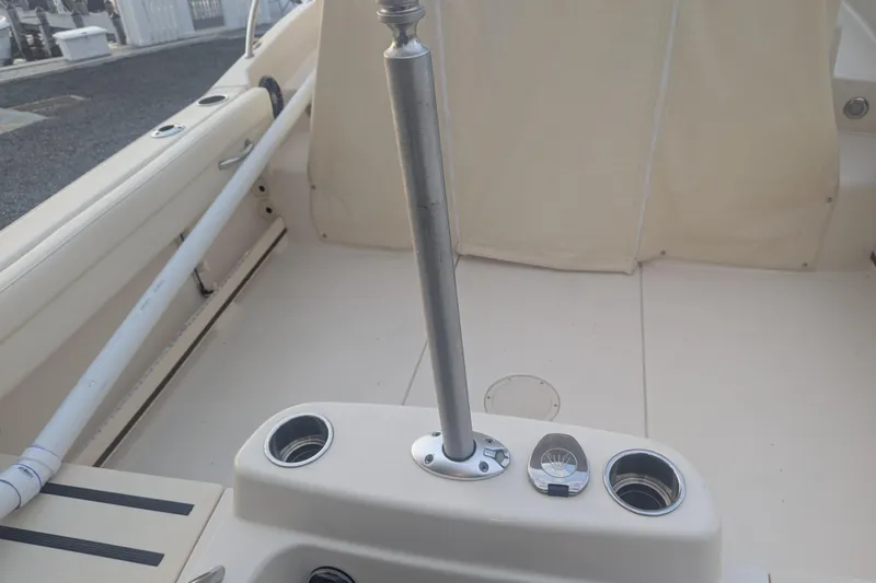 Slide: The Image of 2023 Grady-White Adventure 218 boat interior with rod holders and seating area. - 4