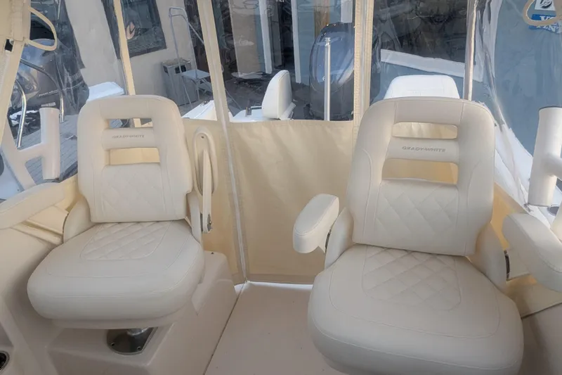 Slide: The Image of 2023 Grady-White Adventure 218 boat interior with two luxurious white seats. - 7