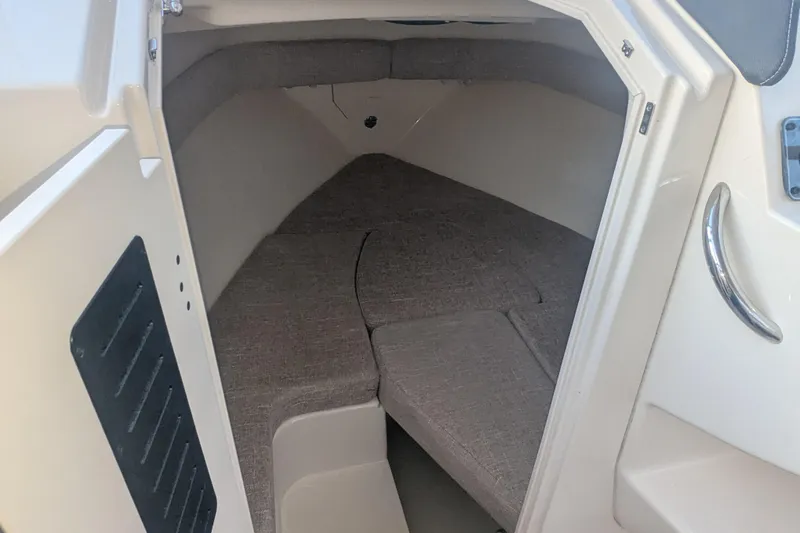 Slide: The Image of 2023 Grady-White Adventure 218 cabin interior with cushioned seating. - 9