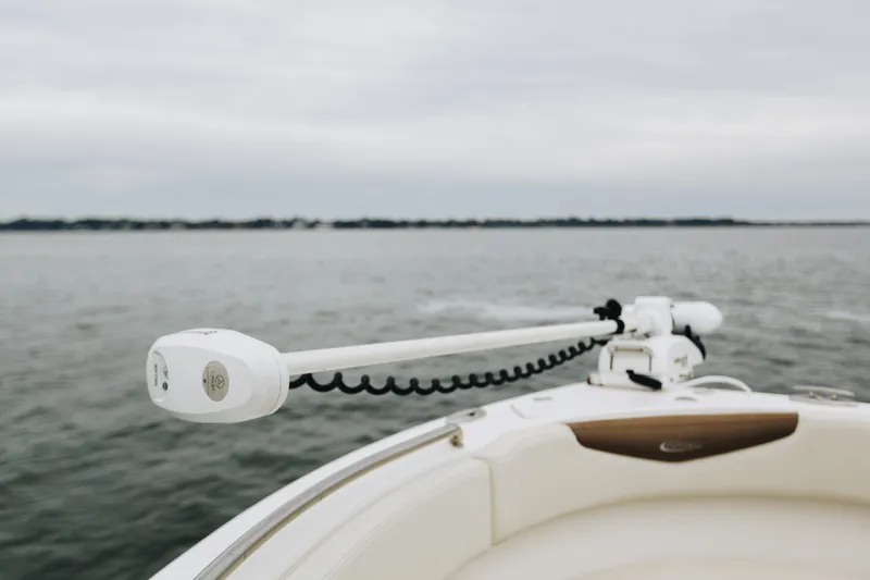 Slide: The Image of 2017 Robalo R222 Center Console boat on calm water, featuring a trolling motor. - 10