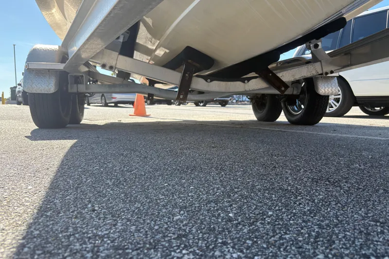 Slide: The Image of Underneath view of a 2017 Robalo R222 boat on a trailer in a parking lot. - 20