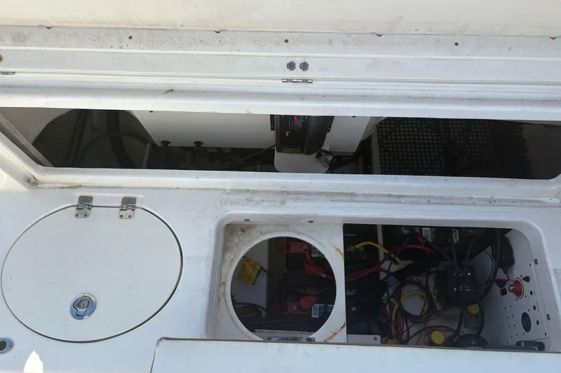 Slide: The Image of 2017 Robalo R222 boat storage compartments with wiring and battery setup. - 22