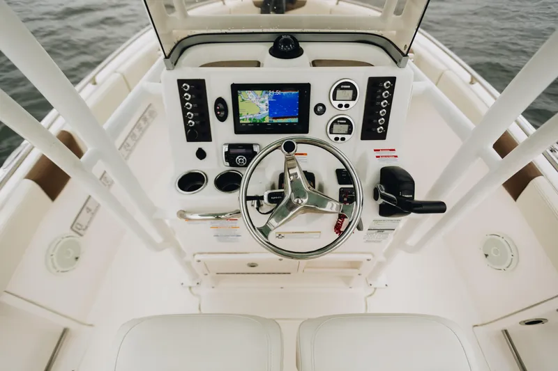 Slide: The Image of 2017 Robalo R222 Center Console boat dashboard with steering wheel and navigation system. - 3