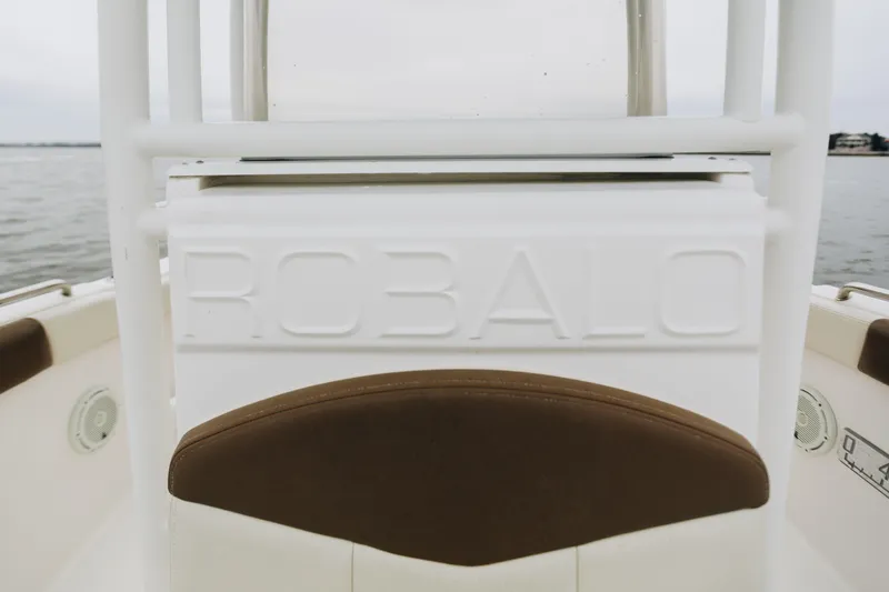 Slide: The Image of 2017 Robalo R222 Center Console boat interior with embossed logo and brown seating. - 7