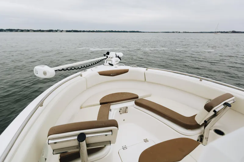 Slide: The Image of 2017 Robalo R222 Center Console boat interior with seating, on calm water. - 9