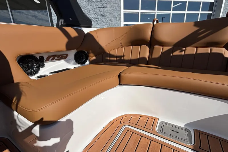 Slide: The Image of 2026 MB SPORTS F21 Classic boat interior with tan leather seating and built-in speakers. - 10