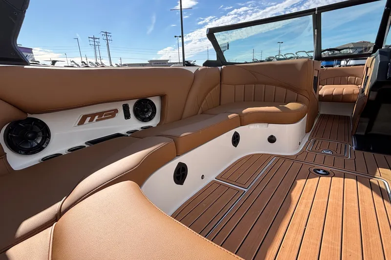 Slide: The Image of Luxurious interior of 2026 MB SPORTS F21 Classic boat with tan seating and wood flooring. - 12