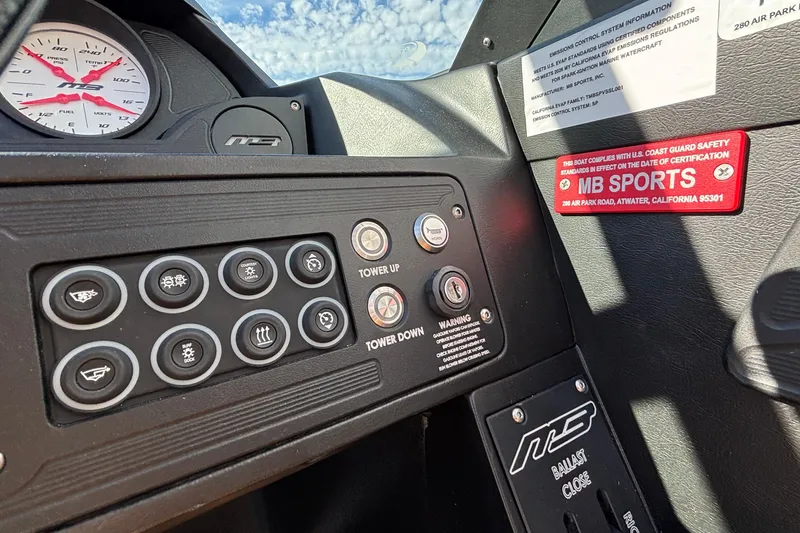 Slide: The Image of Dashboard controls of 2026 MB SPORTS F21 Classic boat with gauges and safety labels. - 19