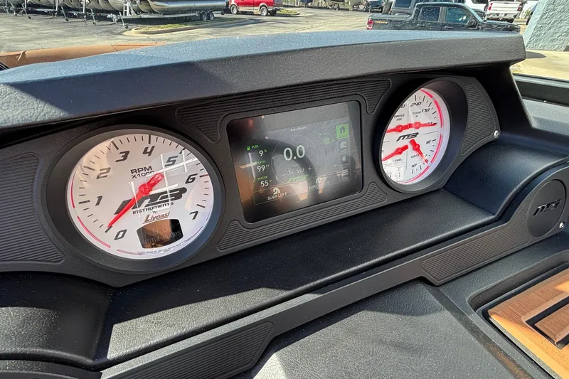 Slide: The Image of Dashboard of 2026 MB SPORTS F21 Classic boat with gauges and digital display. - 21