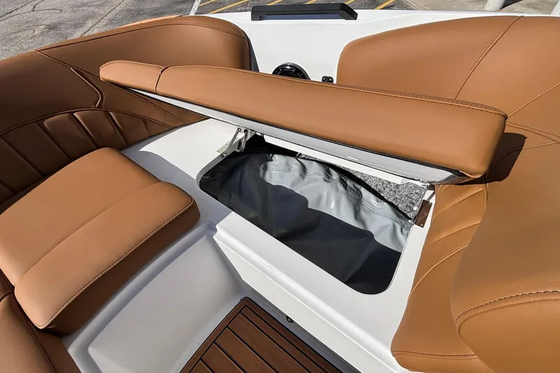 Slide: The Image of 2026 MB SPORTS F21 Classic boat interior with open storage compartment and brown seating. - 37