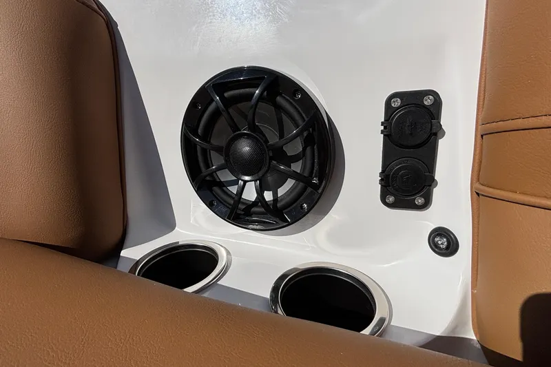 Slide: The Image of 2026 MB SPORTS F21 Classic interior with speaker, cup holders, and brown upholstery. - 38