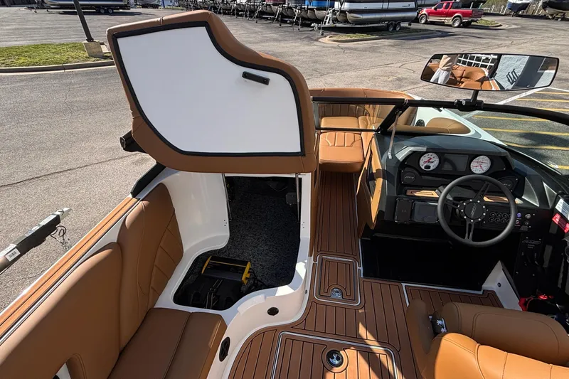 Slide: The Image of 2026 MB SPORTS F21 Classic boat interior with tan seating and modern dashboard. - 41