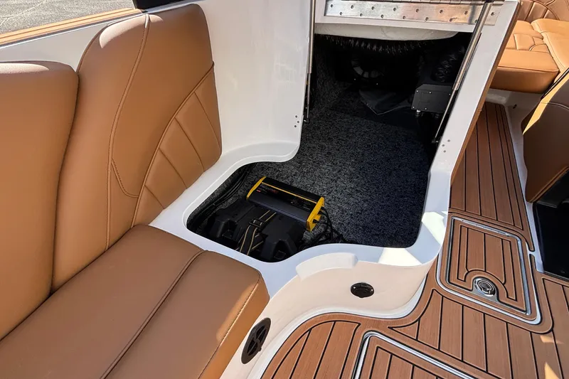 Slide: The Image of 2026 MB SPORTS F21 Classic boat interior with tan seating and storage compartment. - 42