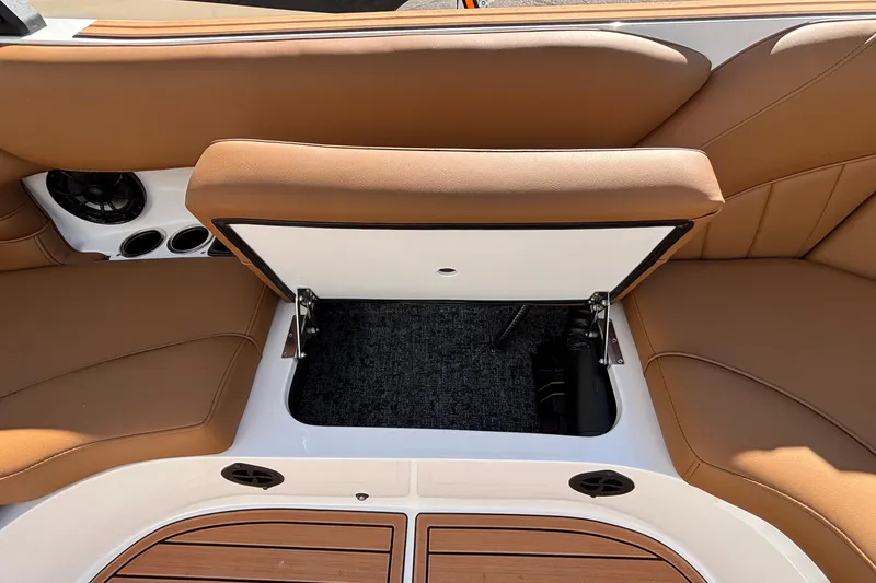 Slide: The Image of 2026 MB SPORTS F21 Classic boat interior with open storage compartment and tan seating. - 43