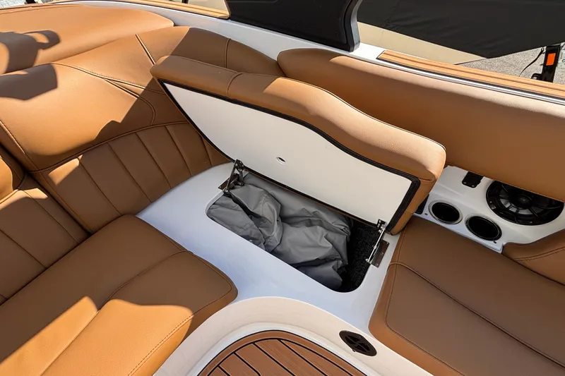 Slide: The Image of 2026 MB SPORTS F21 Classic boat interior with tan leather seats and storage compartment. - 44