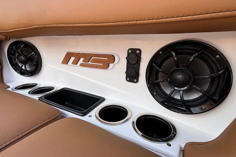 Slide: The Image of 2026 MB SPORTS F21 Classic interior with speakers, cup holders, and logo detail. - 47