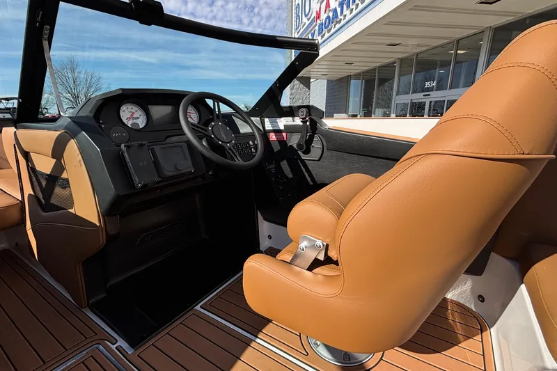 Slide: The Image of Interior of 2026 MB SPORTS F21 Classic boat with tan leather seats and modern dashboard. - 48