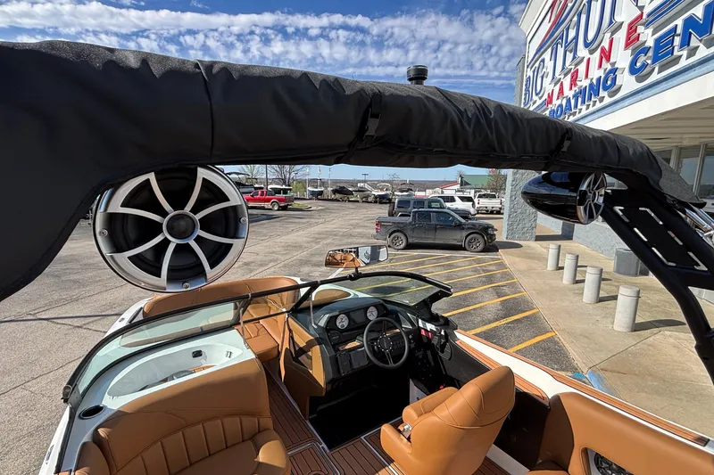 Slide: The Image of 2026 MB SPORTS F21 Classic boat interior with speakers, parked at a marina. - 49
