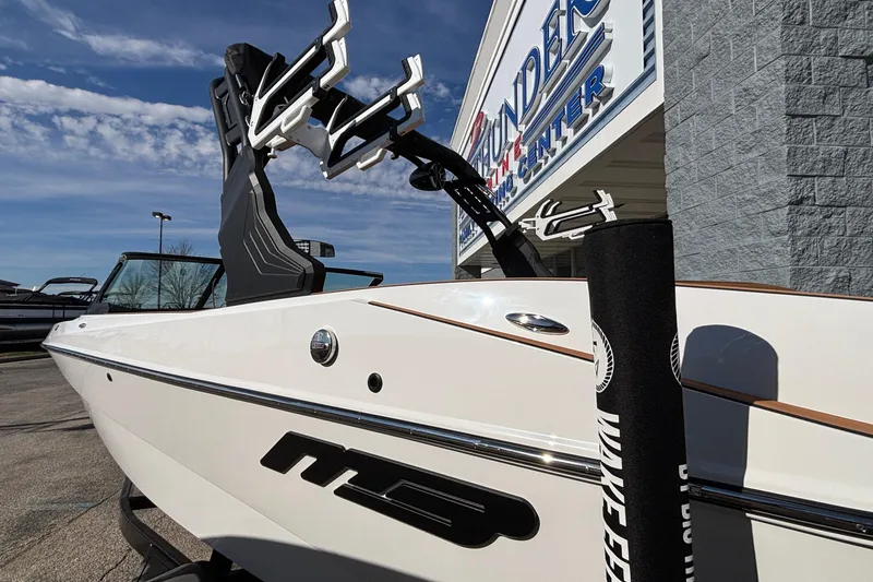 Slide: The Image of 2026 MB SPORTS F21 Classic boat at dealership, showcasing sleek design and wakeboard tower. - 50