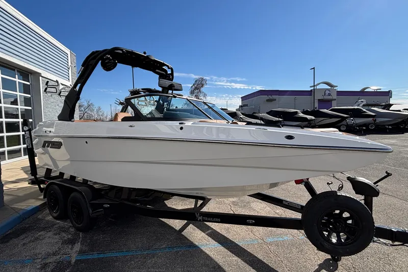 Slide: The Image of 2026 MB SPORTS F21 Classic boat on trailer, parked outdoors under clear sky. - 54