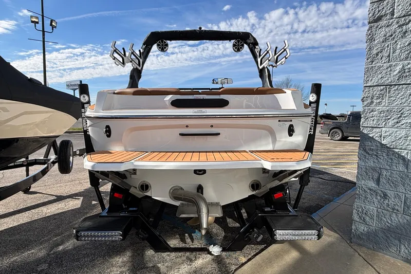 Slide: The Image of 2026 MB SPORTS F21 Classic boat, rear view, parked outdoors under a blue sky. - 57