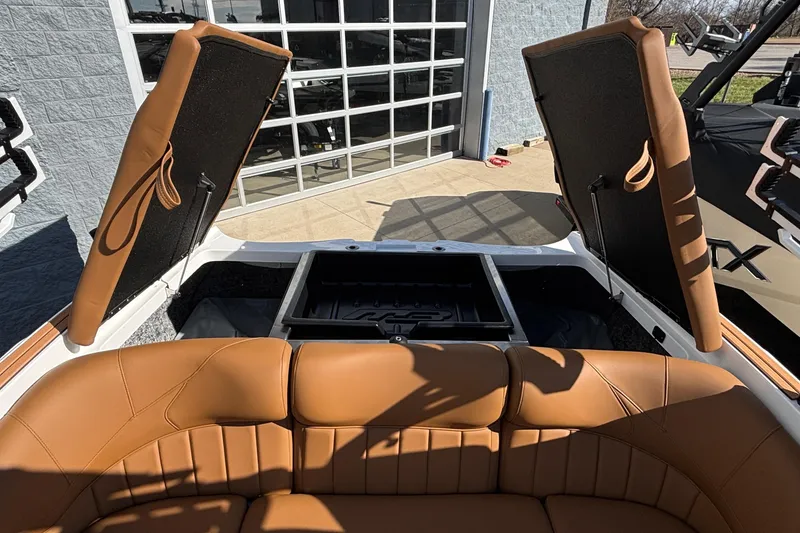 Slide: The Image of 2026 MB SPORTS F21 Classic boat interior with tan leather seats and open storage compartments. - 6