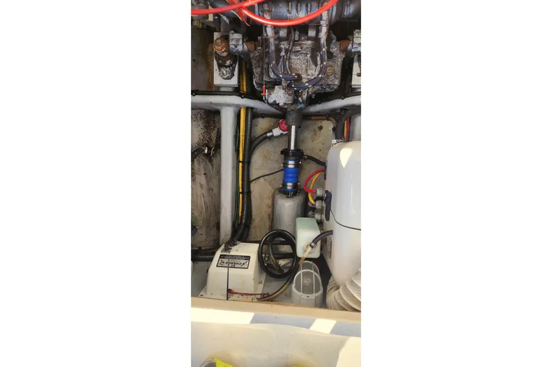 Slide: The Image of Engine compartment of a 2003 Mainship Pilot 30-II boat, showing mechanical components. - 12