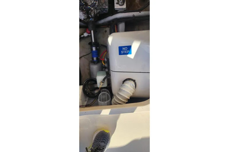 Slide: The Image of Engine compartment of 2003 Mainship Pilot 30-II with "No Step" label visible. - 13