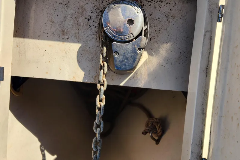 Slide: The Image of Anchor chain and windlass on a 2003 Mainship Pilot 30-II boat deck. - 16