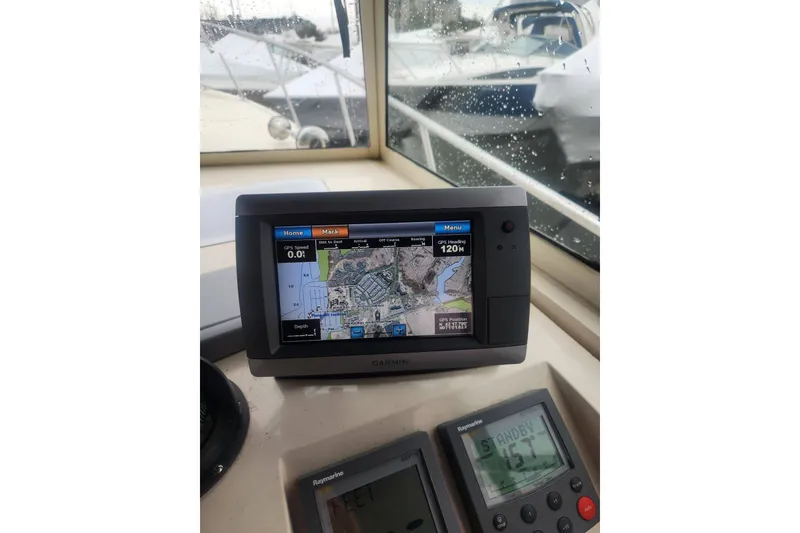 Slide: The Image of 2003 Mainship Pilot 30-II boat cockpit with Garmin navigation system and Raymarine instruments. - 18